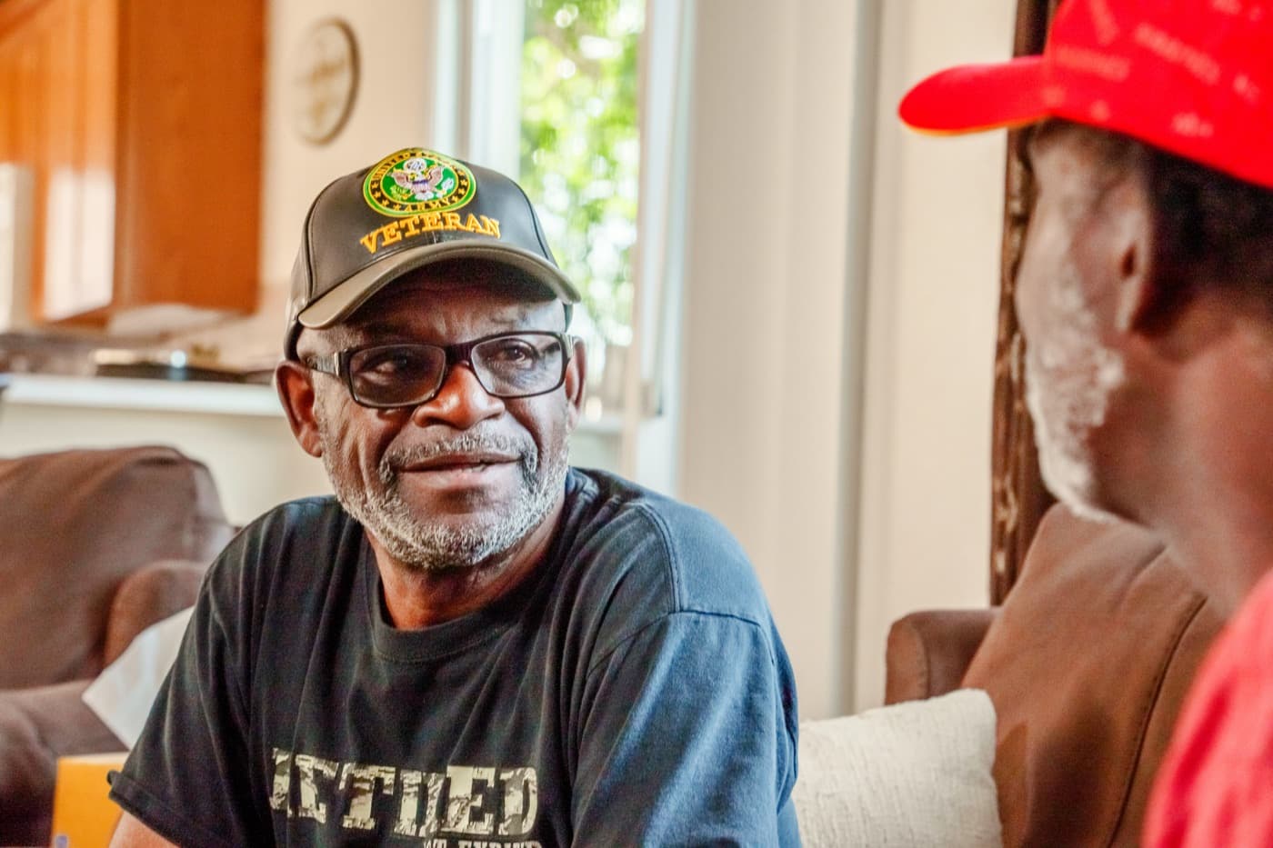 A veteran smiling in conversation at home